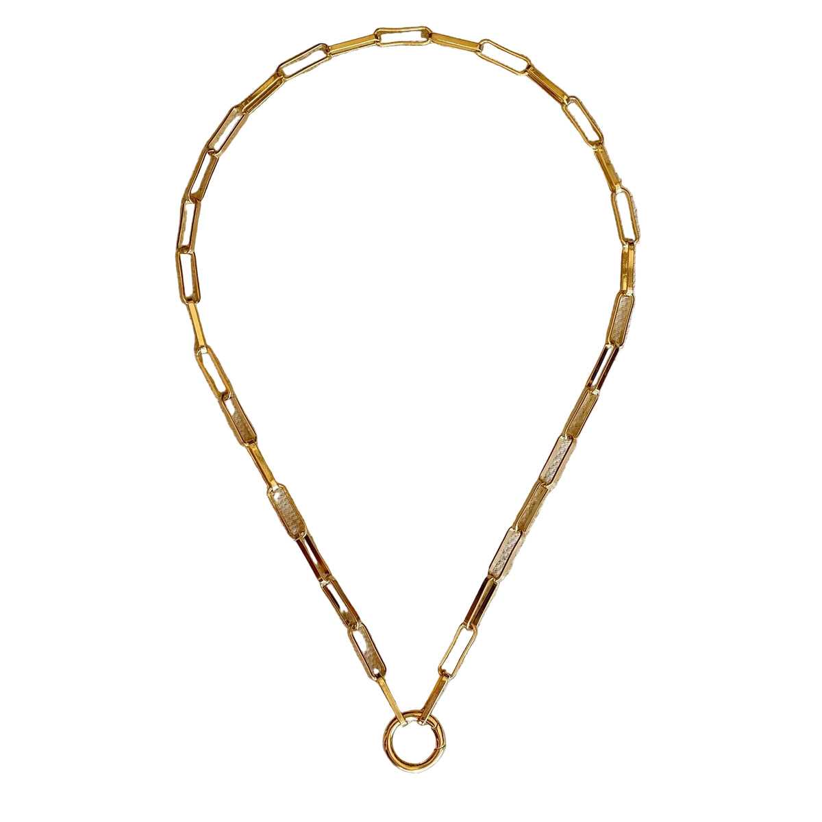 Gold necklace on a beige fabric background