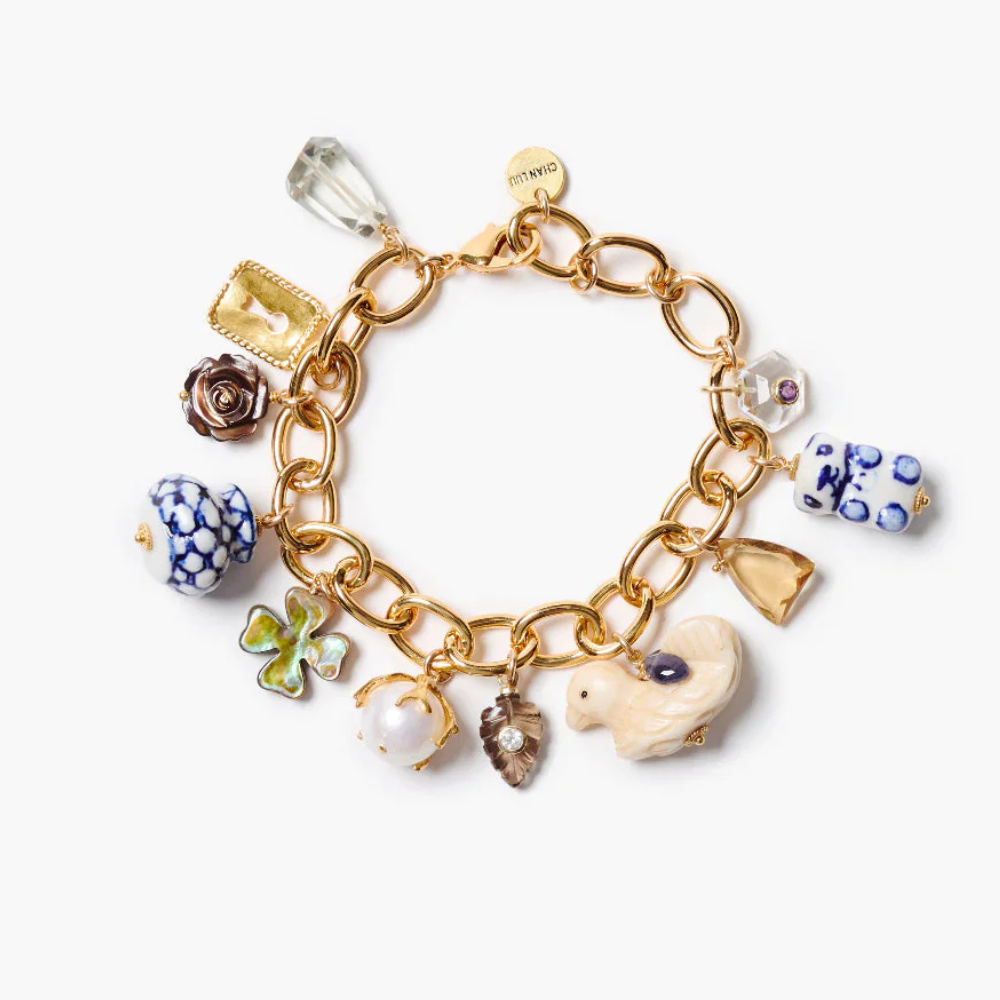 Gold charm bracelet with various colorful charms on a white background