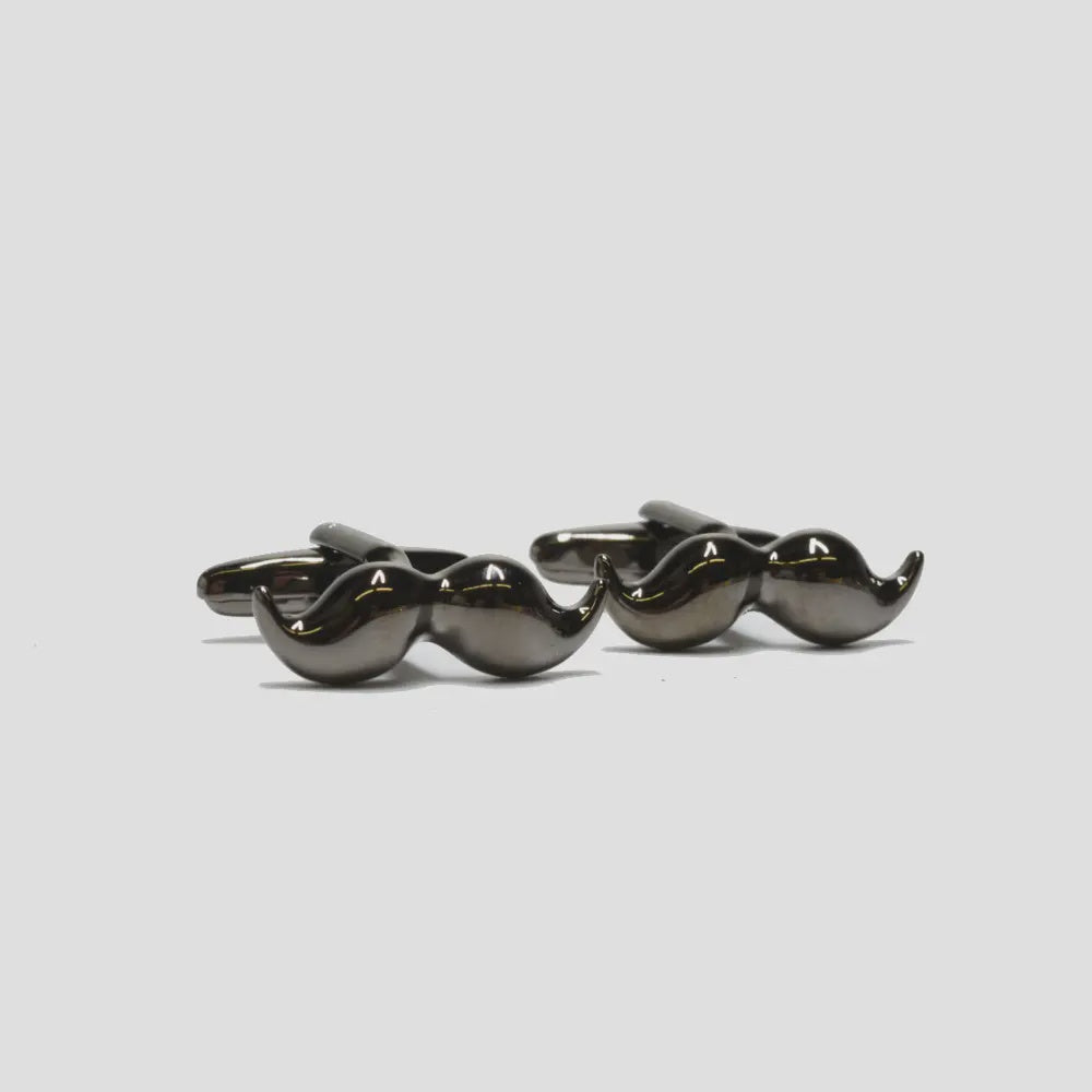 Three black mustache-shaped cufflinks on a light gray background