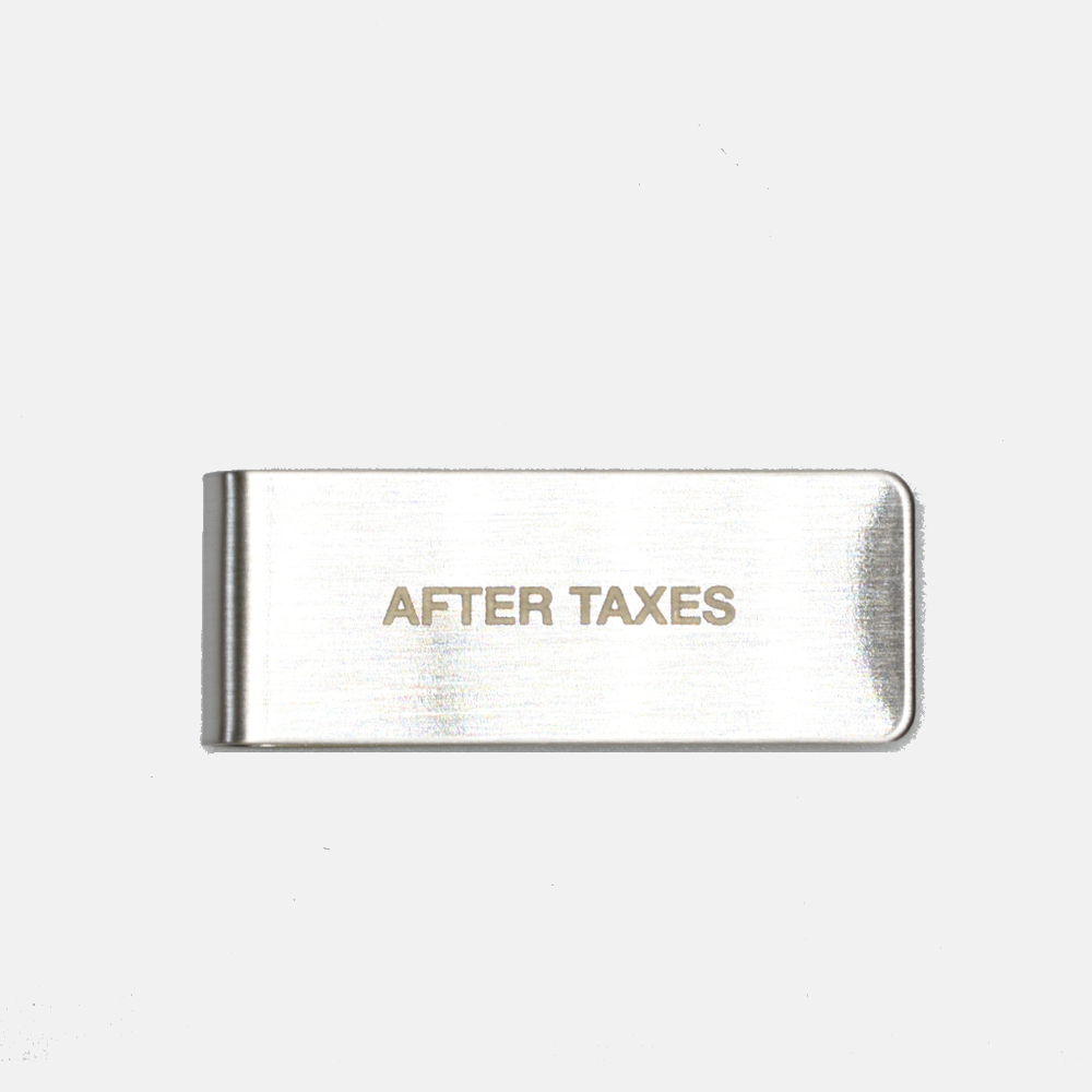 A steel money clip with the embossed text 'AFTER TAXES' on it, presented on a plain background.