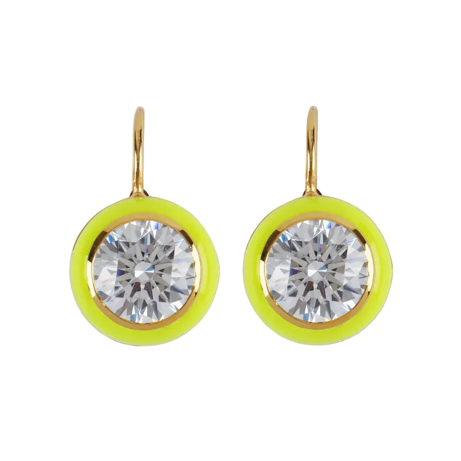 Pair of earrings with clear gemstones and yellow circular accents on a light beige background