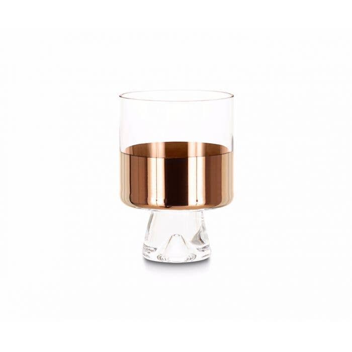 A clear low ball glass with hand-painted copper detailing on the inside, presented against a white background.