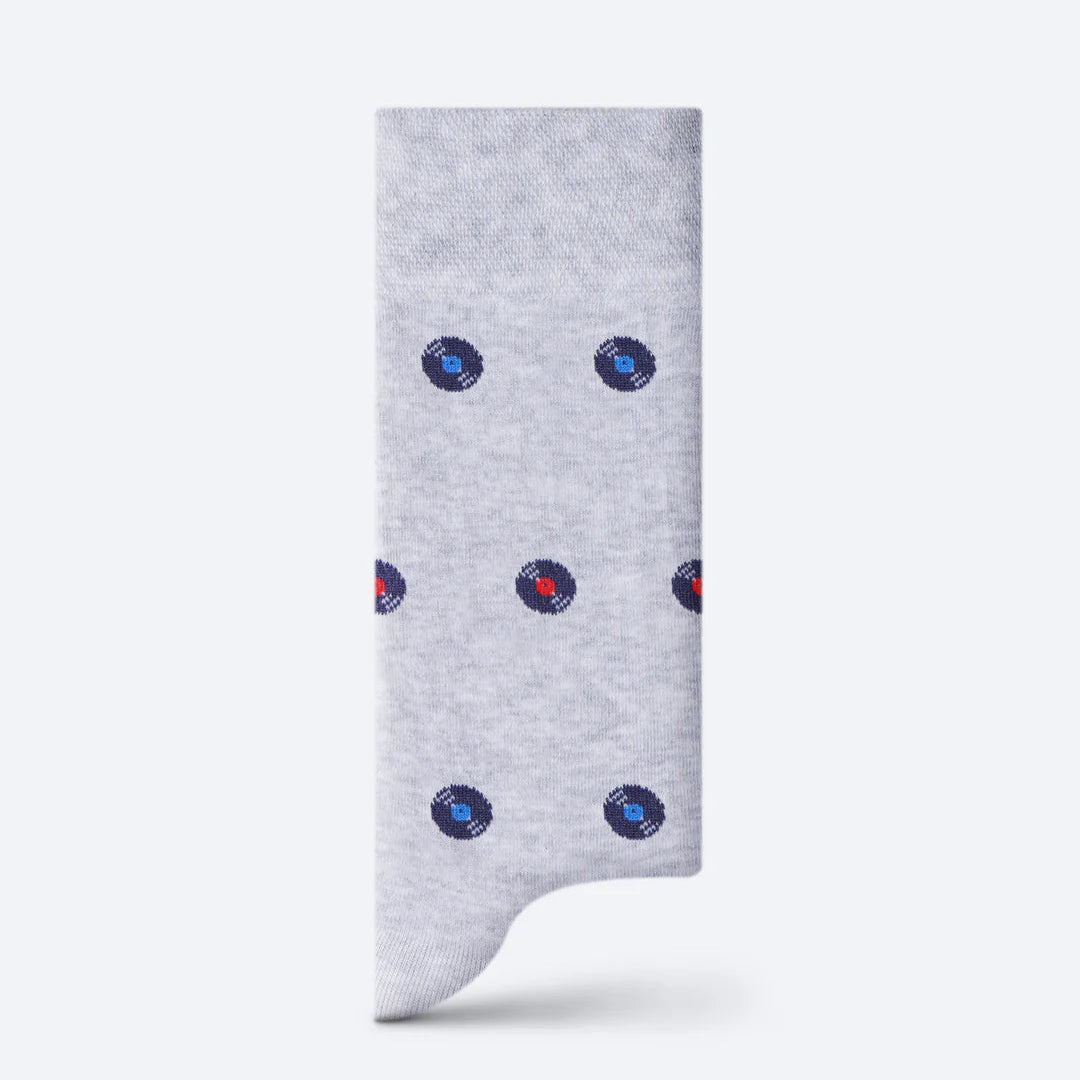 Gray sock with blue and red polka dots on a white background