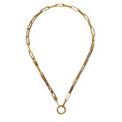 Gold necklace on a beige fabric background