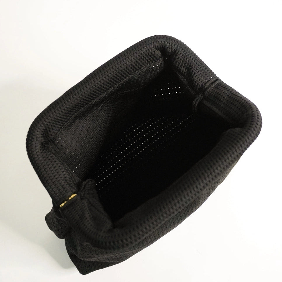 Black plastic tray with multiple small cups on a white background