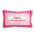 Decorative pillow with 'Karma is my boyfriend' text and heart patterns on a white background