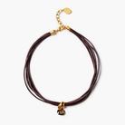 Brown leather cord necklace with gold clasp on a white background