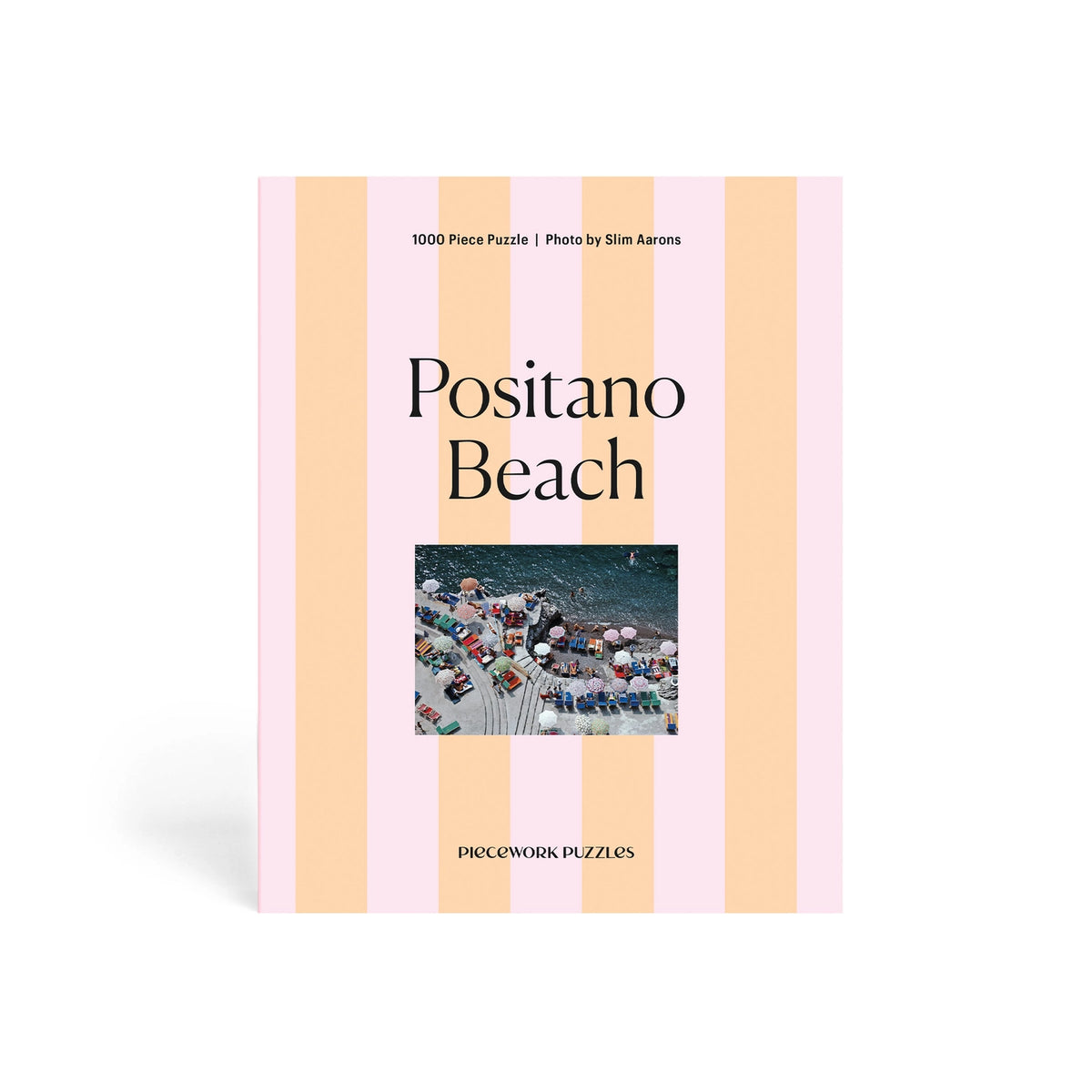 Pacifica Puzzle Co. Positano Beach puzzle packaging with striped design and photo of beach scene.