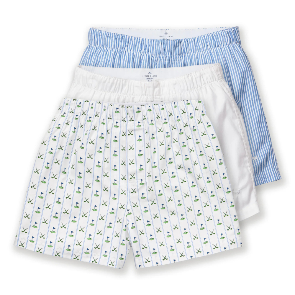 Three pairs of boxer shorts, one with a blue striped pattern and the other with a white and green golf pattern, on a white background.