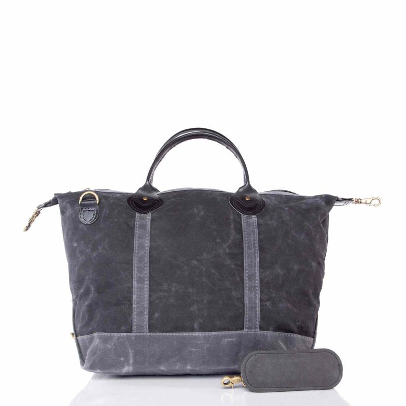 Gray waxed canvas bag with black leather handles on a white background
