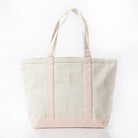 Beige tote bag with pink accents on a white background
