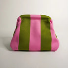Pink and green striped fabric bag on a light gray background