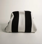 Black and white striped pouch on a light gray background