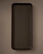 Rectangular dark brown tray on a matching brown background