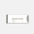 A steel money clip with the embossed text 'AFTER TAXES' on it, presented on a plain background.