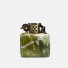A kerosene lighter with a solid brass body and a green marble-like base, featuring a brushed finish and mechanical ignition system.