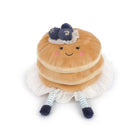 Plush toy resembling a stack of pancakes with blueberries on a white background