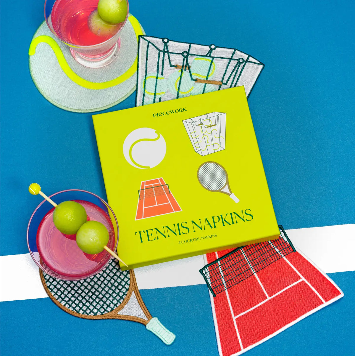 Tennis-themed napkin set with a glass of pink drink on a blue background