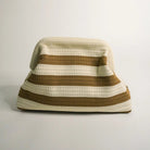 Crocheted hat with brown and beige stripes on a light gray background