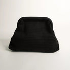 Black textured clutch bag on a light gray background