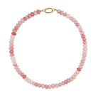 Necklace with pink and red beaded chain on a light gray background