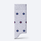 Gray sock with blue and red polka dots on a white background