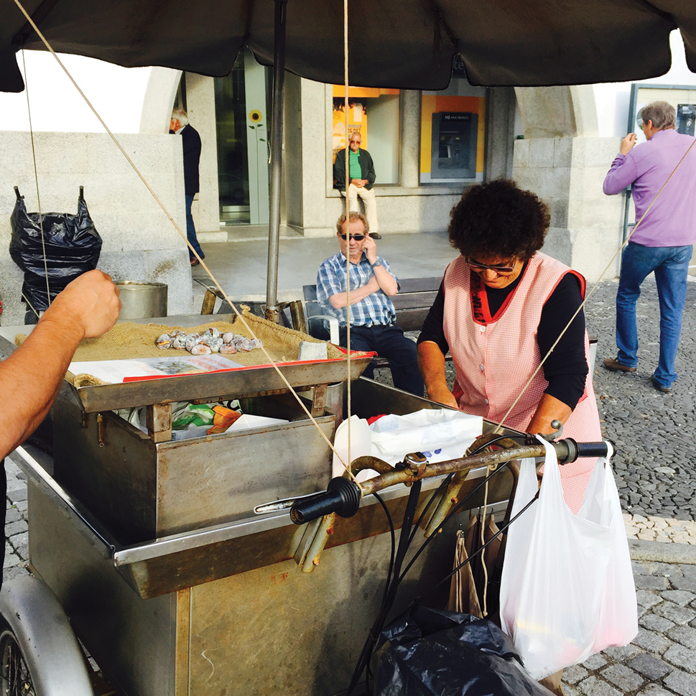 A roasted chestnut street vendor in Evora. โThe locals looked at me as someone from there and I know what's worth seeing," says Rui Correia.