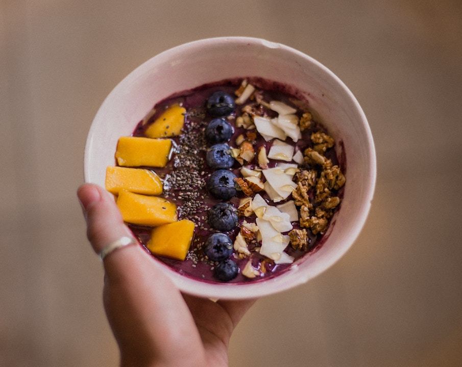 An acai bowl in a person's hand