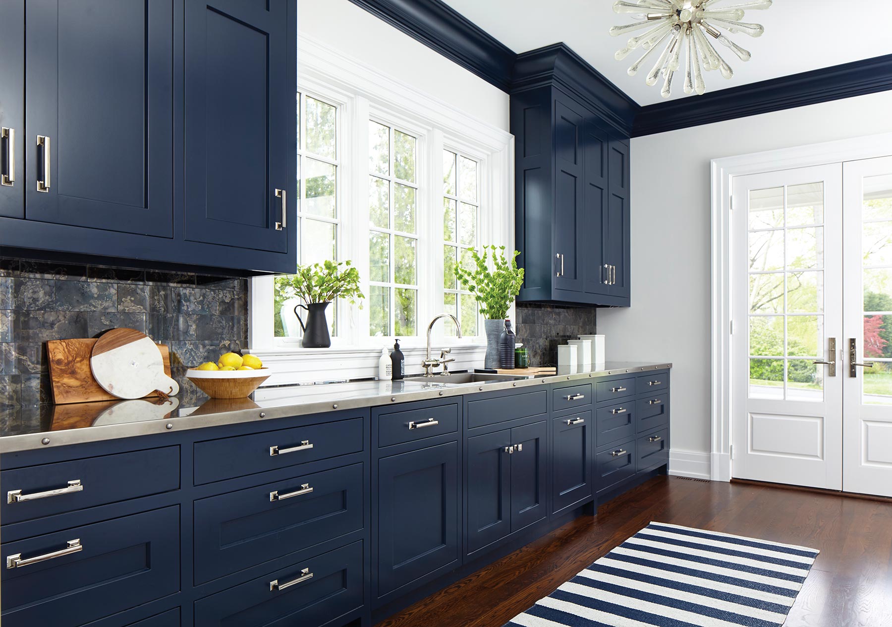 An all blue buffet area off the side of a kitchen.