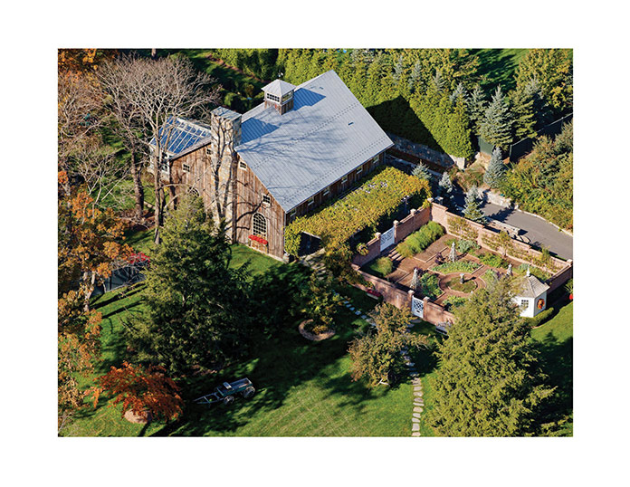 A reclaimed barn was transformed into an entertaining space with adjacent traditional parterre garden.