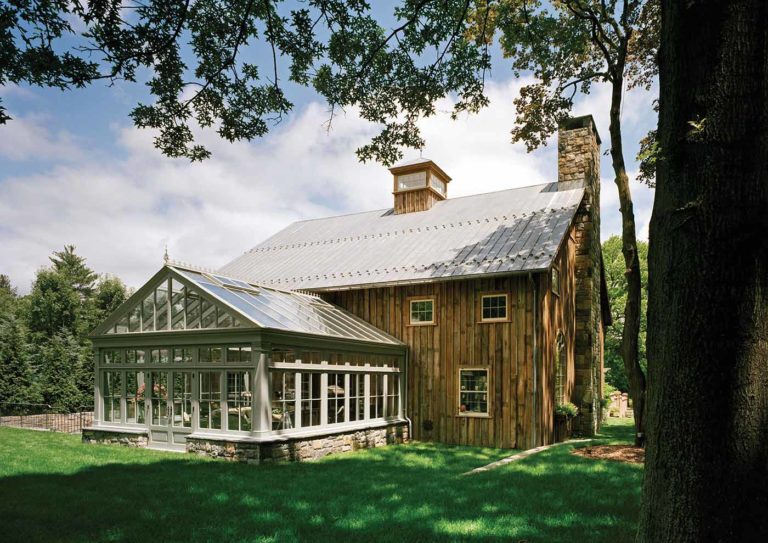 An interior English greenhouse provides a sunny spot for conversation.