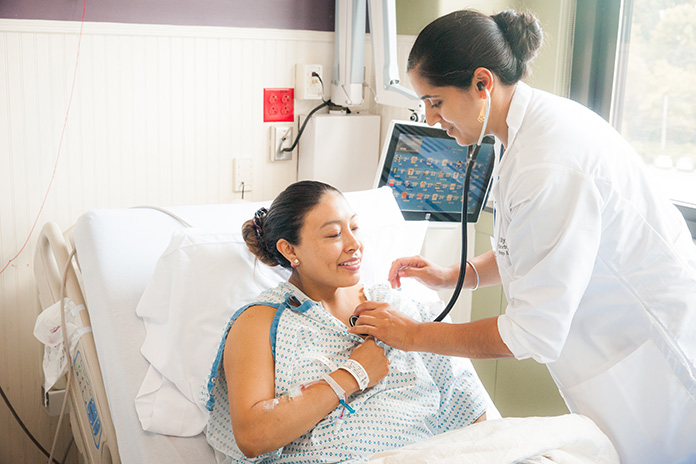 Doctor using a stethoscope on patient