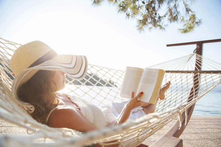 Woman laying on a hammock on the beach
