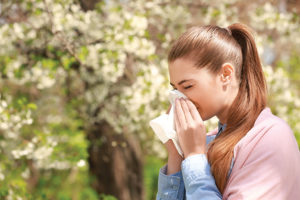 Woman blowing her nose