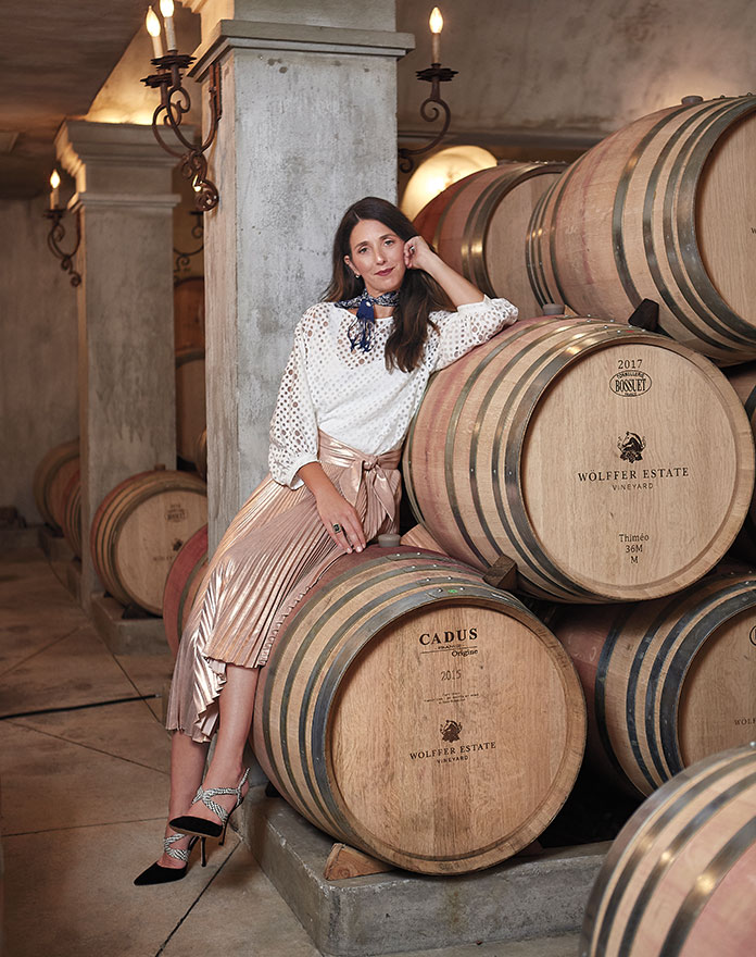 Joey Woffler sitting on wine barrels
