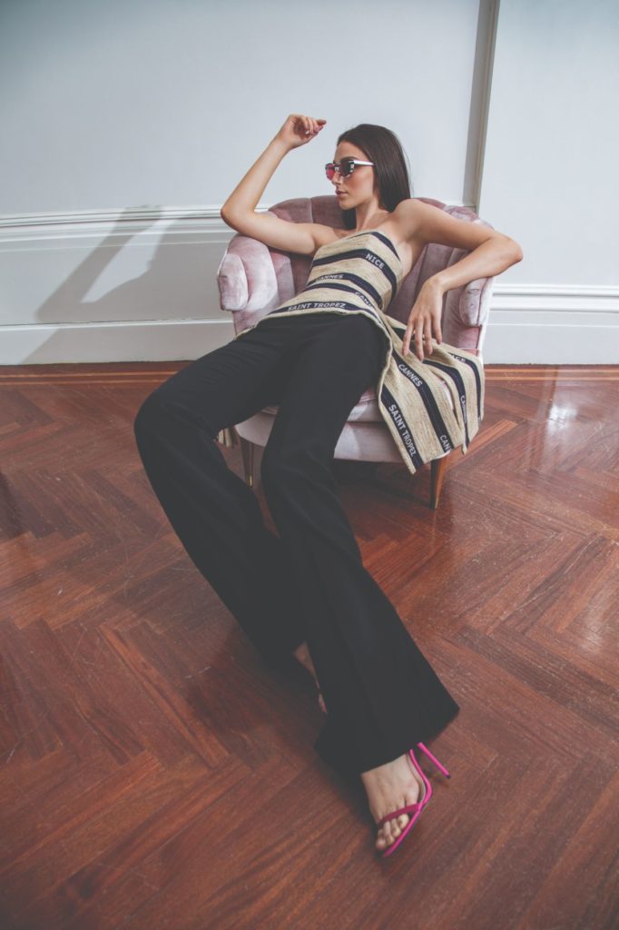 model sitting in chair