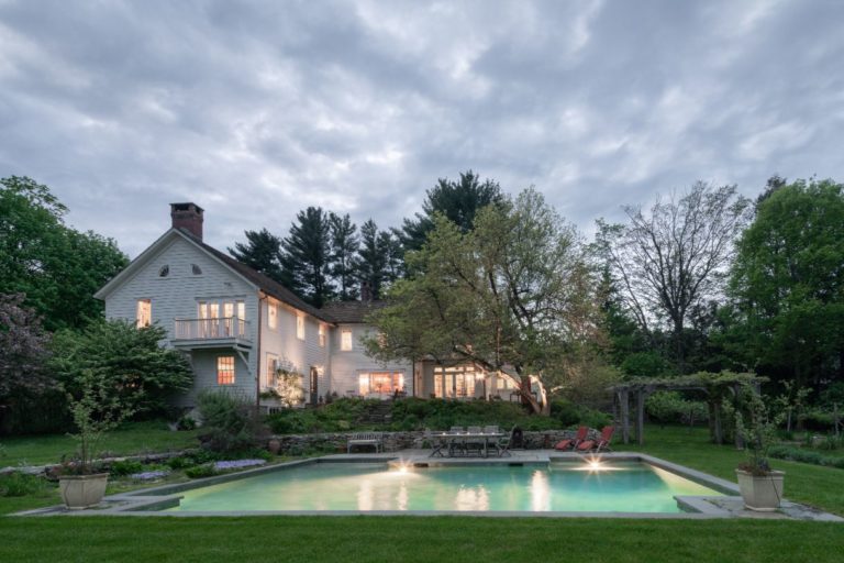 exterior view of pool and house at night