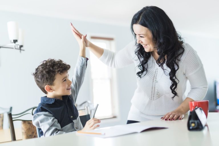 women and boy high fiving